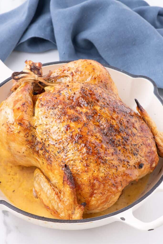 oven roasted chicken in a white cast iron skillet