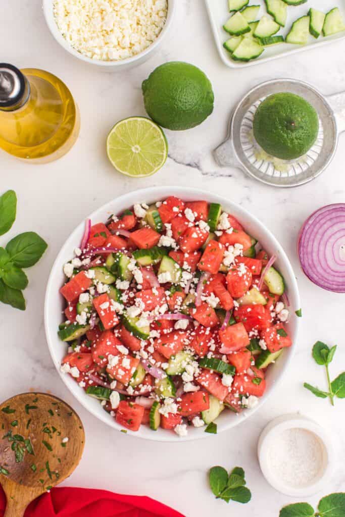 adding feta cheese to summer salad 