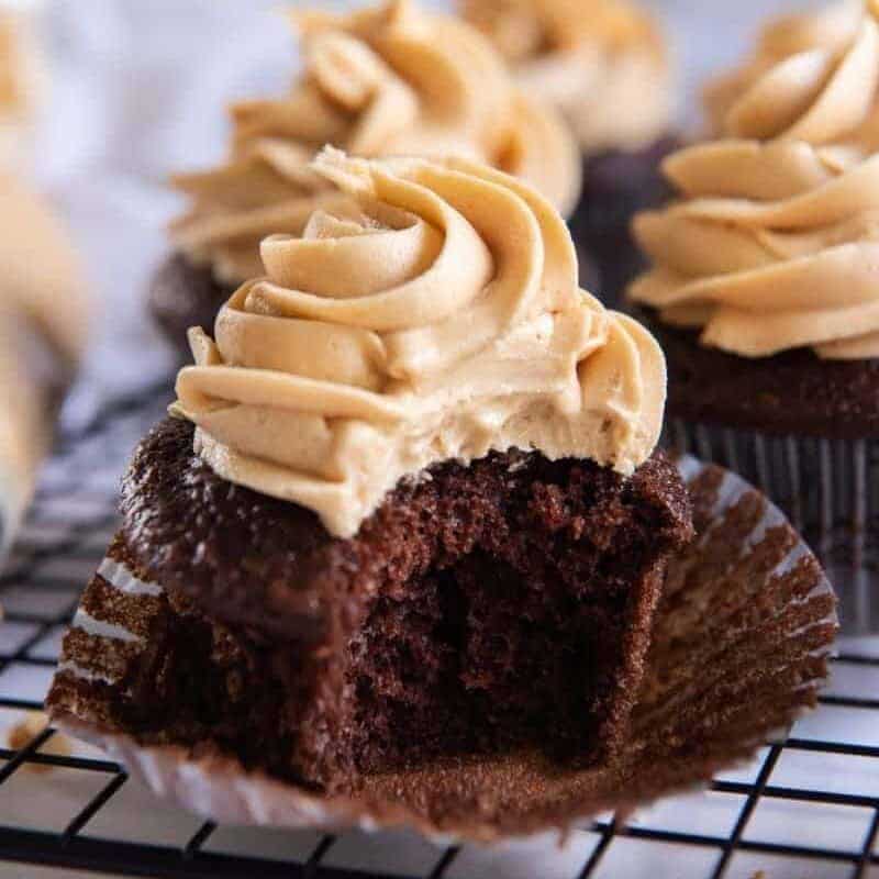 Cupcake with bite taken out topped with peanut butter frosting