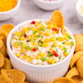 a bowl of fiesta corn dip with scoopable Frito chips