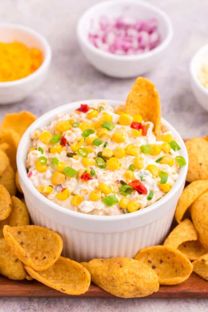 a bowl of fiesta corn dip with scoopable Frito chips