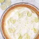 homemade key lime pie with whipped cream and lime zest