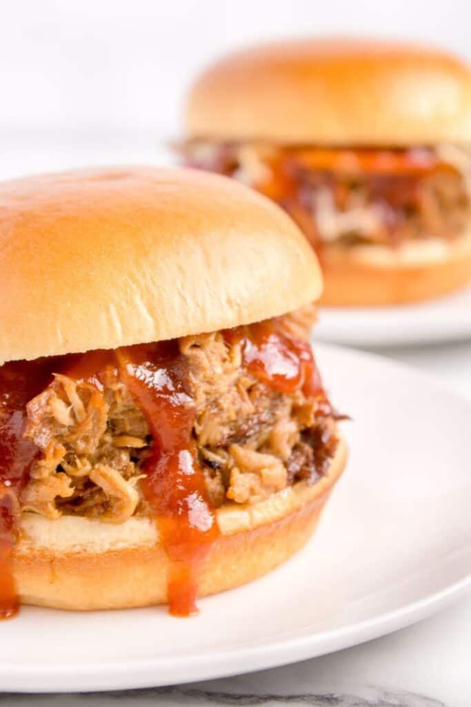 shredded pork in a hamburger bun with bbq sauce