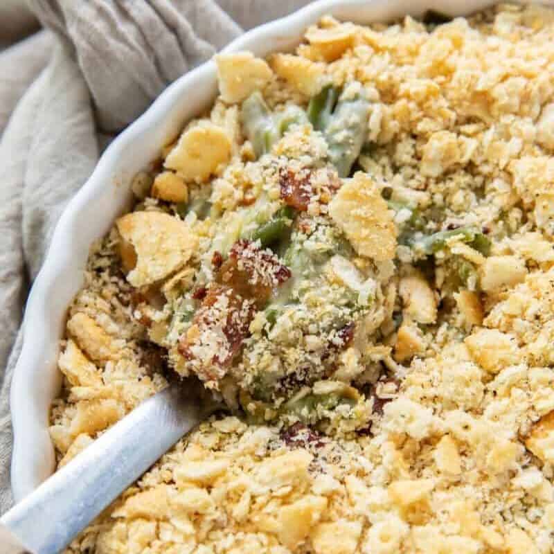 Green Bean Casserole in a round casserole dish with a serving spoon inside