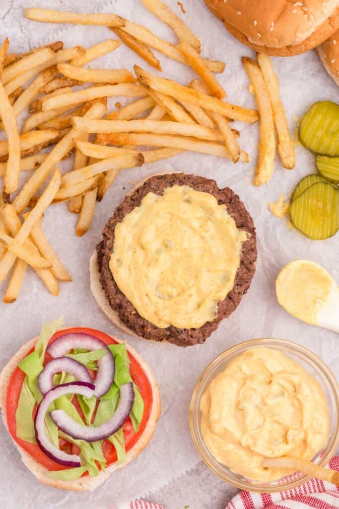 adding mcdonalds sauce to burger patty