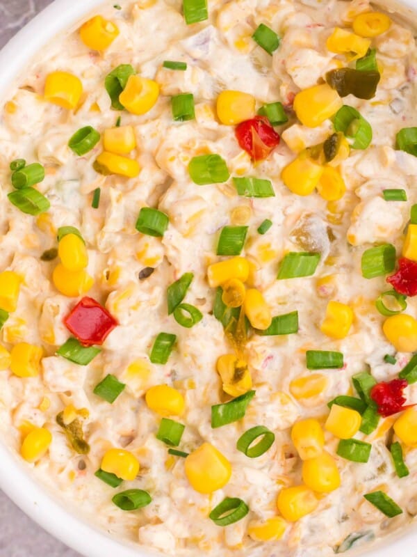 Close up of the corn dip with fritos in a serving bowl.