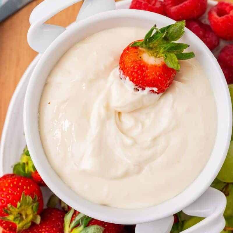 dipping fruit into a cream cheese dip.