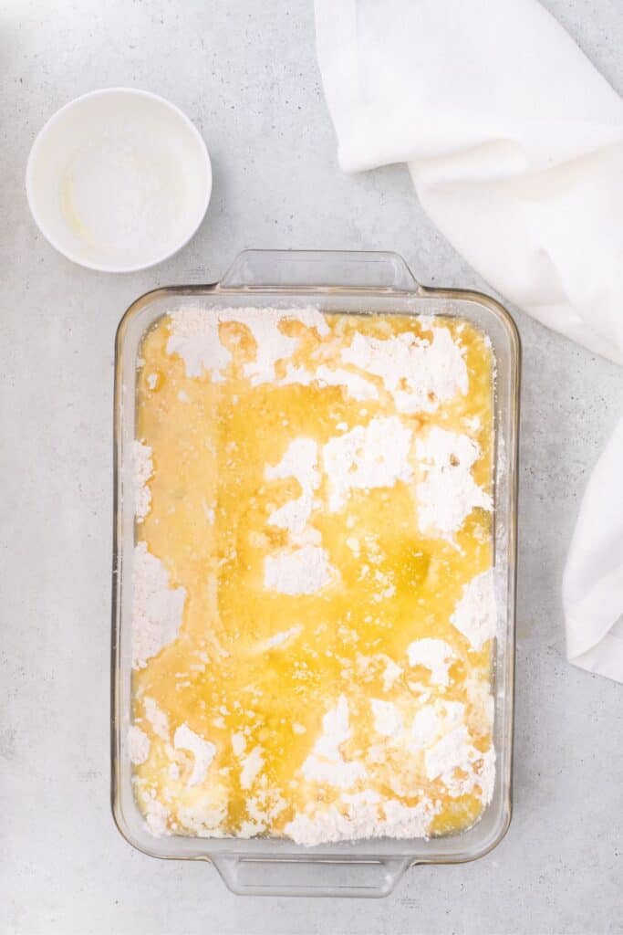 pineapple cake mix ingredients in glass pan.