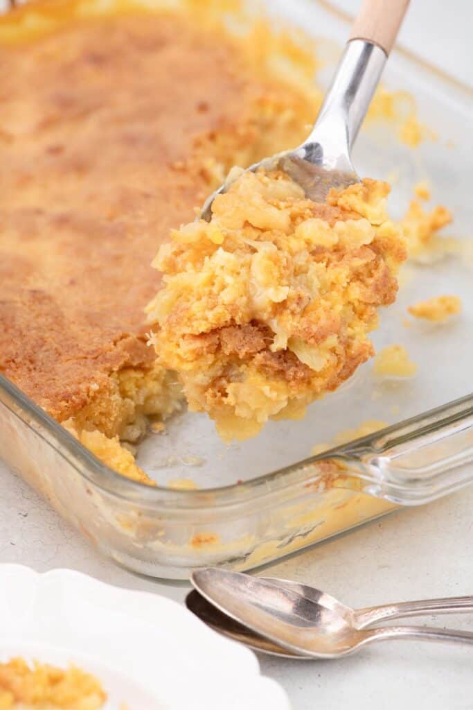 homemade cake on serving spoon from glass baking dish.