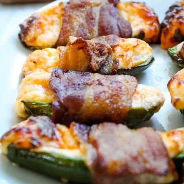 Bacon Wrapped Jalapeno Poppers with full jalapeno in background