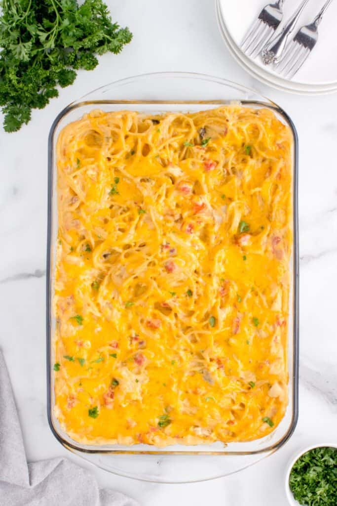 Baked chicken spaghetti with Rotel in a casserole dish overhead view.