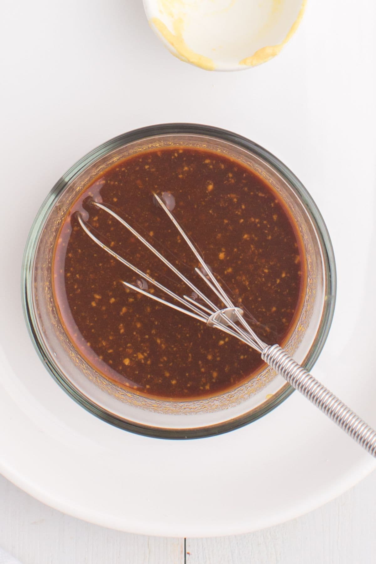 Steak marinade being whisked together in a bowl.