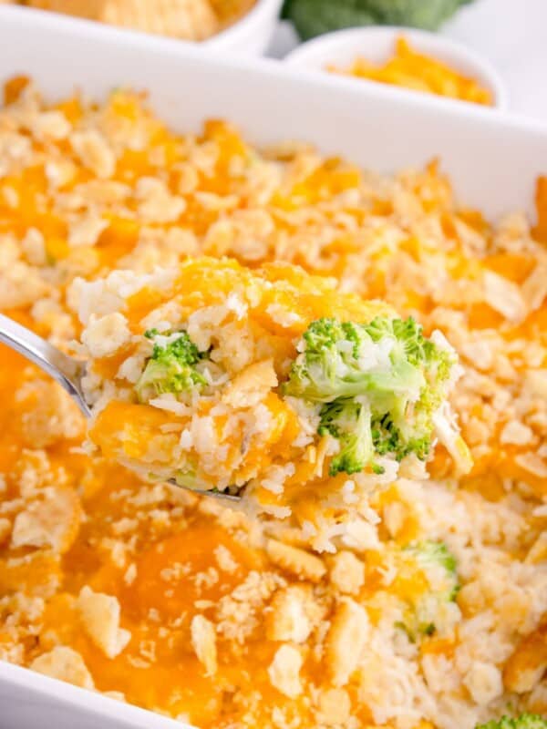 Baking dish with the completed casserole. A serving spoon is lifting a scoop of casserole out of the dish.