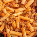 Close up of pasta bolognese in a large skillet.