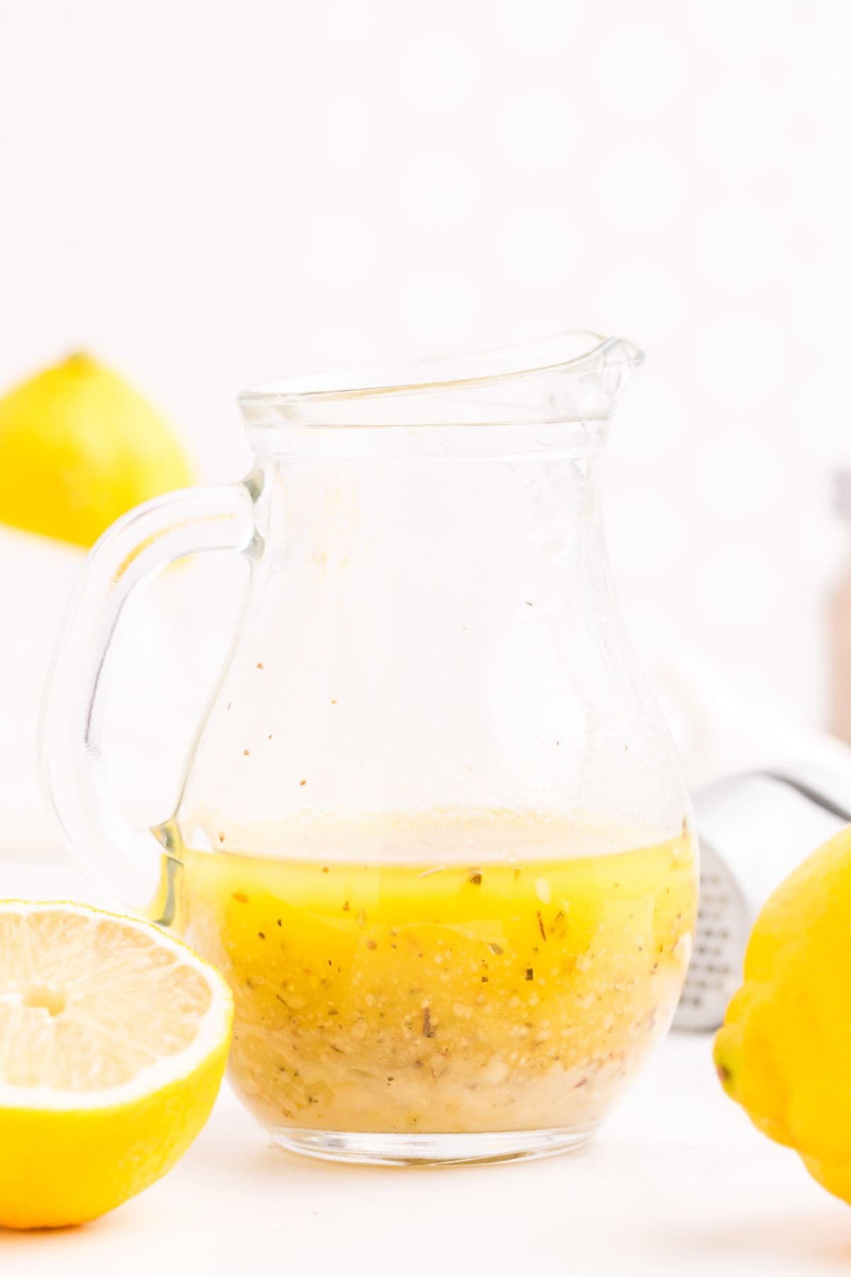 The lemon vinaigrette dressing in a pitcher.