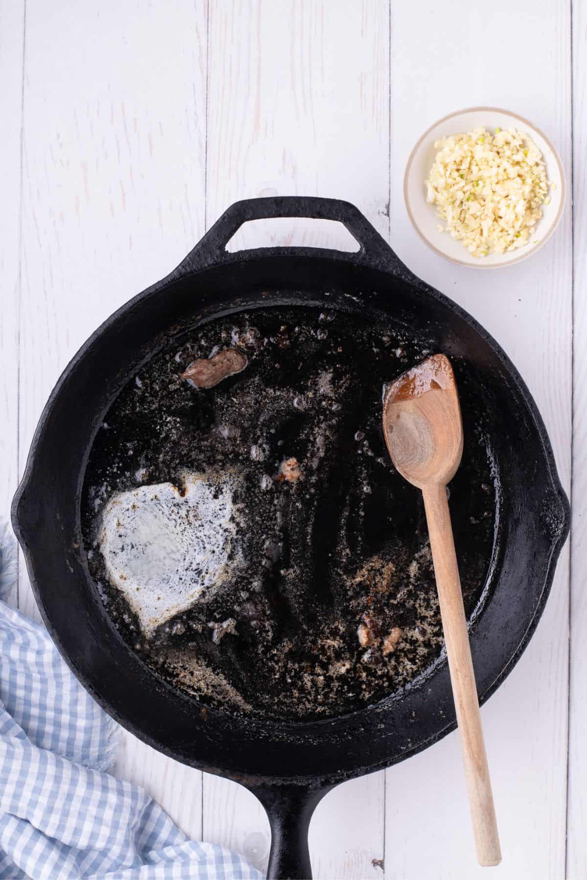 Scraping the browned bits off the pan so it creates more flavor in the dish.
