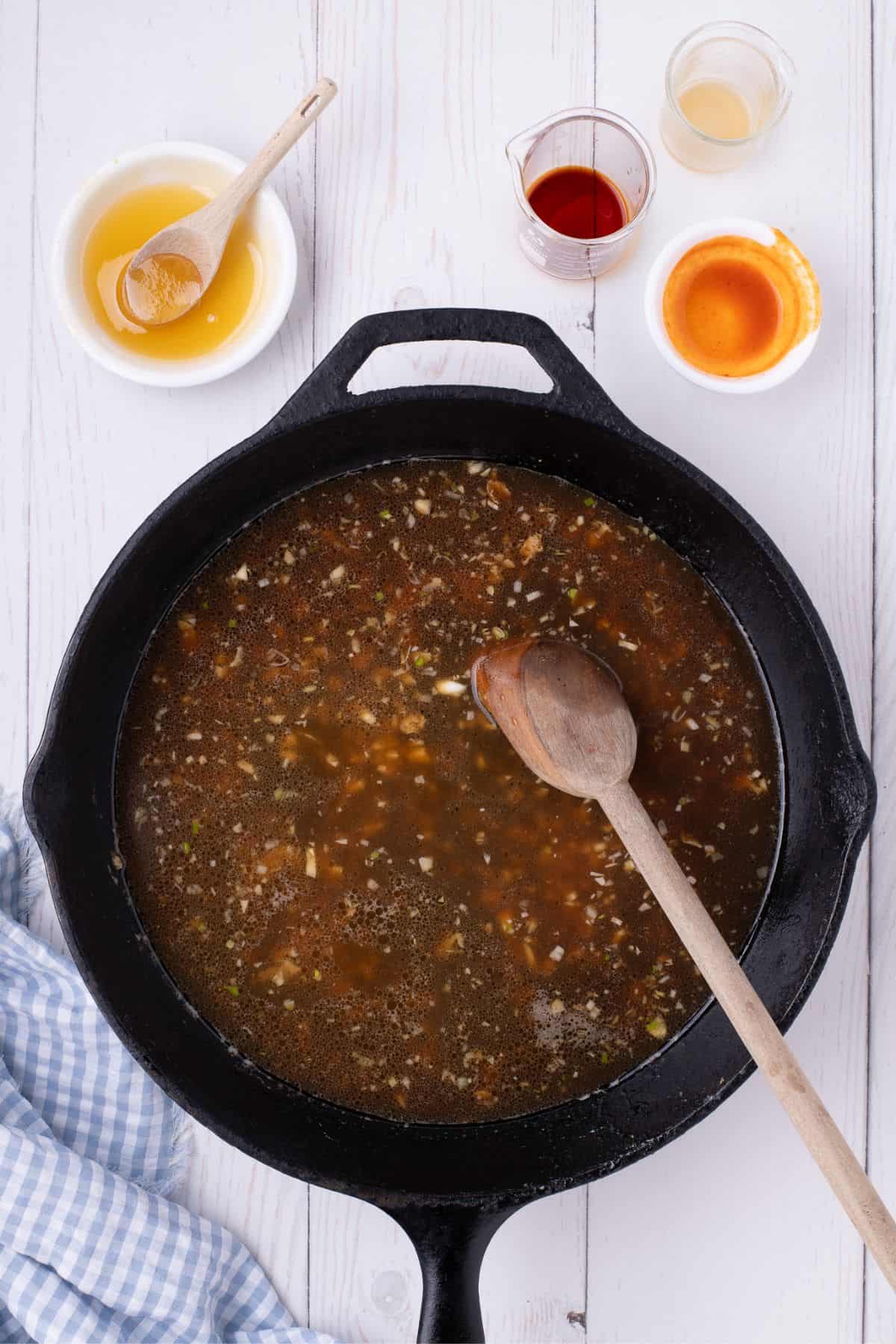 Adding the honey, chicken broth, Better Than Bouillon, and other seasonings for the sauce.