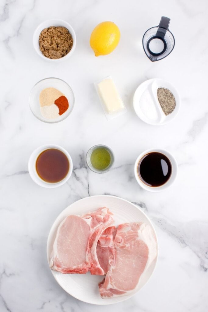 Ingredients for brown sugar pork chops: pork chops, salt, black pepper, onion powder, garlic powder, paprika, oil, brown sugar, soy sauce, Worcestershire sauce, lemon juice, and butter.