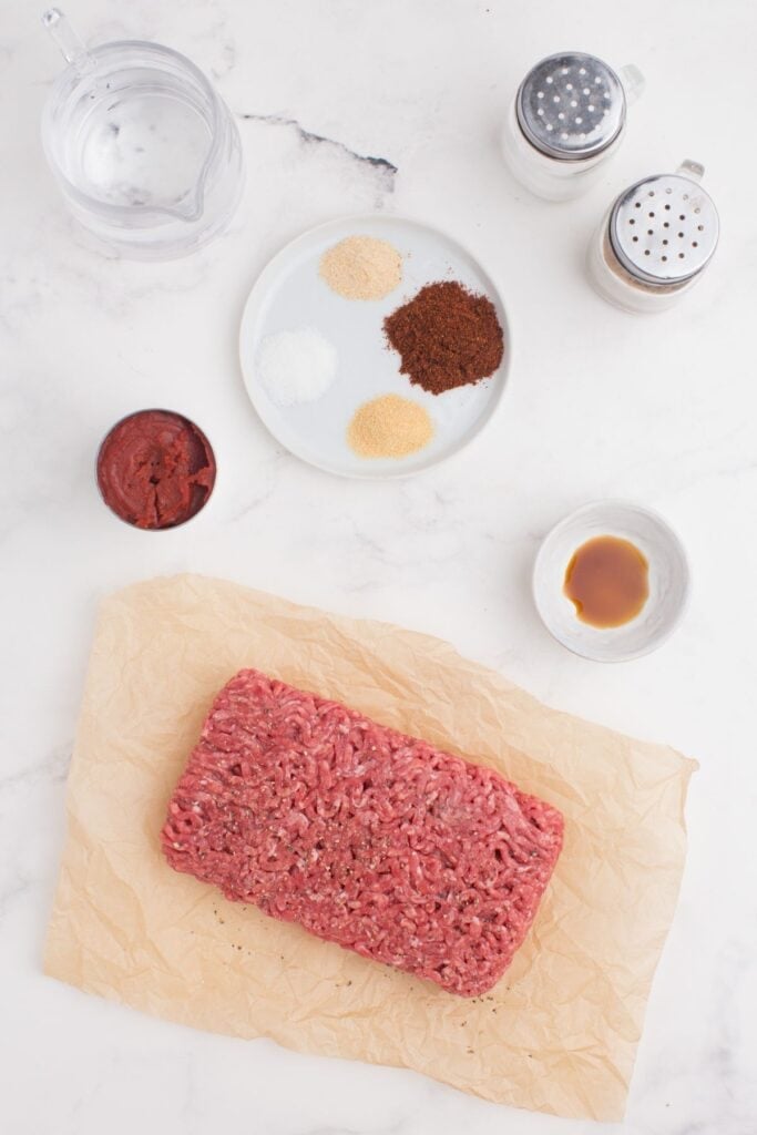Ingredients for hot dog chili: ground beef, water, tomato paste, chili Powder, sugar, garlic powder, onion powder, and Worcestershire sauce.
