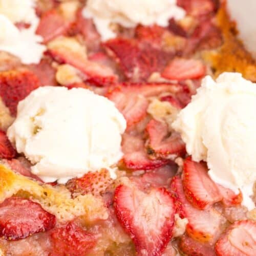 Close up view of strawberry cobbler in a baking dish.