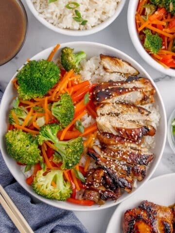 Completed chicken teriyaki bowl with white rice, chicken, peppers, carrots, and broccoli.