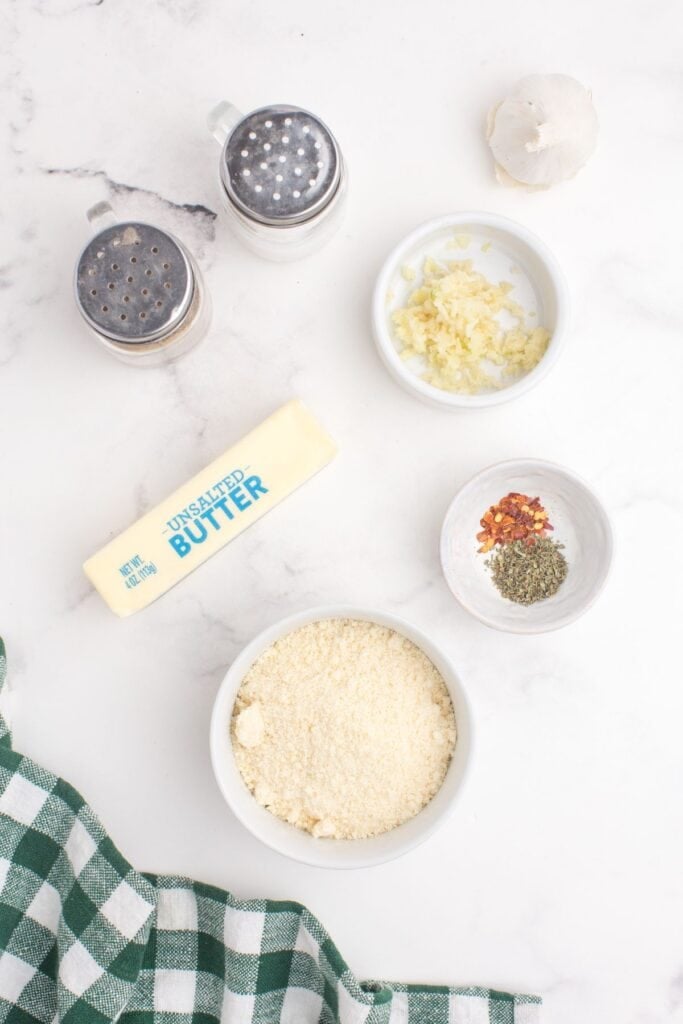 Ingredients for garlic parmesan sauce: butter, minced garlic, Italian seasoning, grated parmesan, red crushed pepper, salt, and pepper.