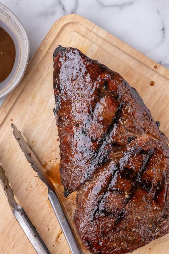 London broil resting on a cutting board.