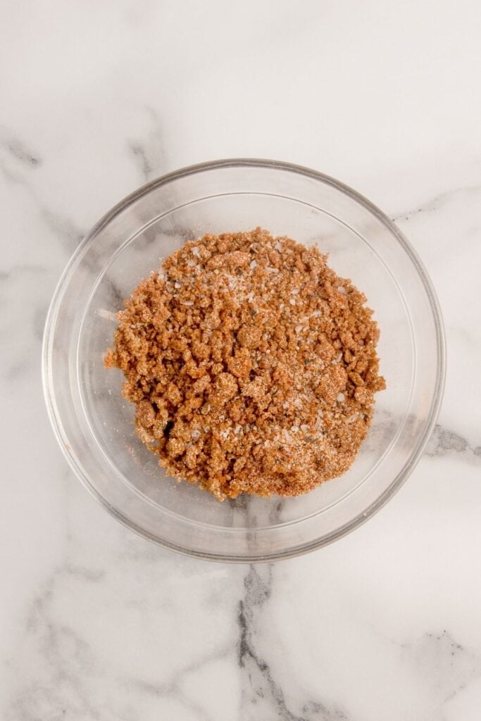 Seasoning mixture of salt, smoked paprika, black pepper, garlic powder, onion powder, and brown sugar in a small glass bowl.