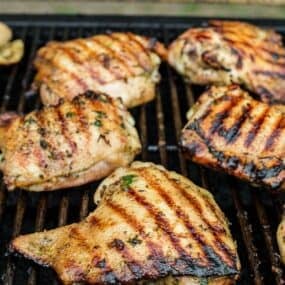 Chicken cooking on a grill.