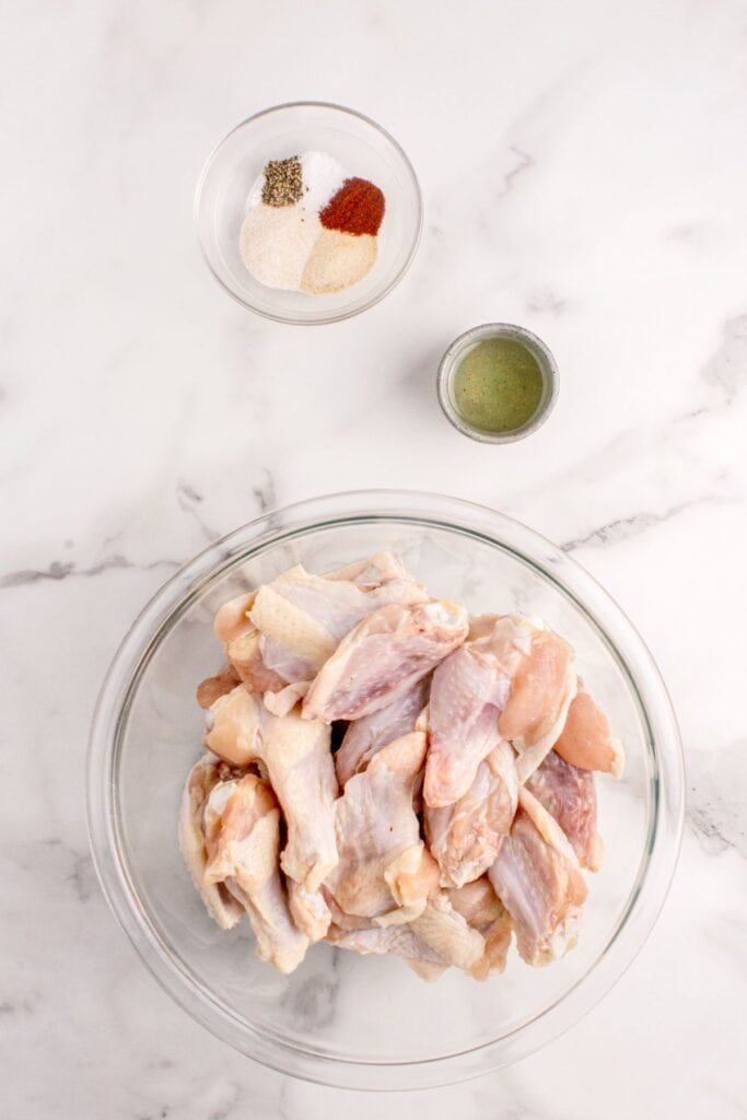 Ingredients for baked chicken wings: chicken wings, olive oil, garlic powder, onion powder, smoked paprika, salt, and black pepper.