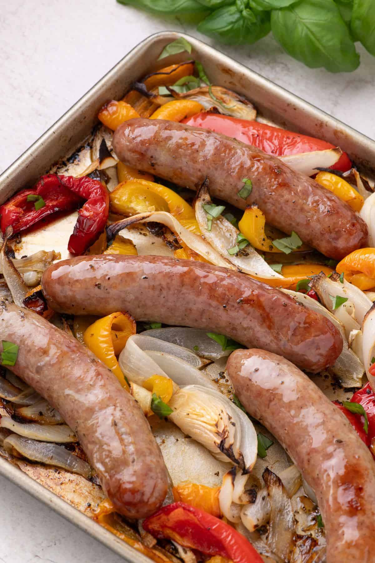 Close up of the cooked Italian sausage on the baking sheet.