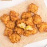 Corn nuggets piled up on a sheet of parchment paper.