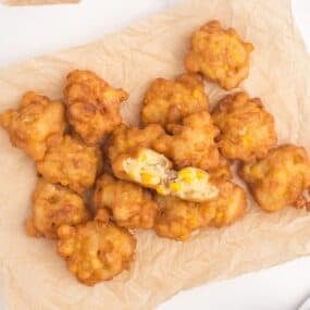 Corn nuggets piled up on a sheet of parchment paper.