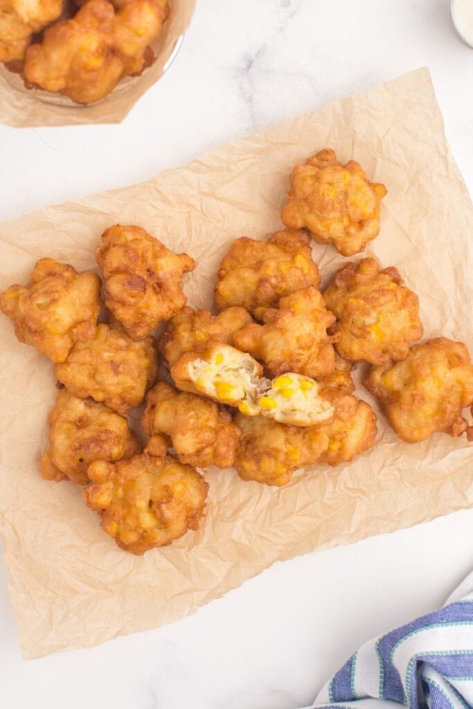 Corn nuggets piled up on a sheet of parchment paper.