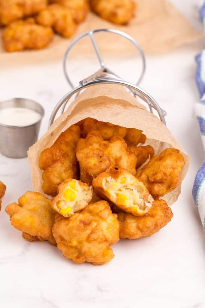 Fry stand on it's side with corn nuggets spilling out of it.