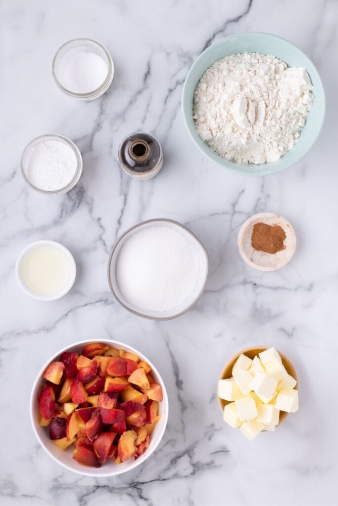 Ingredients for peach bars: flour, sugar, baking powder, salt, butter, peaches, ground cinnamon, lemon juice, and vanilla extract.