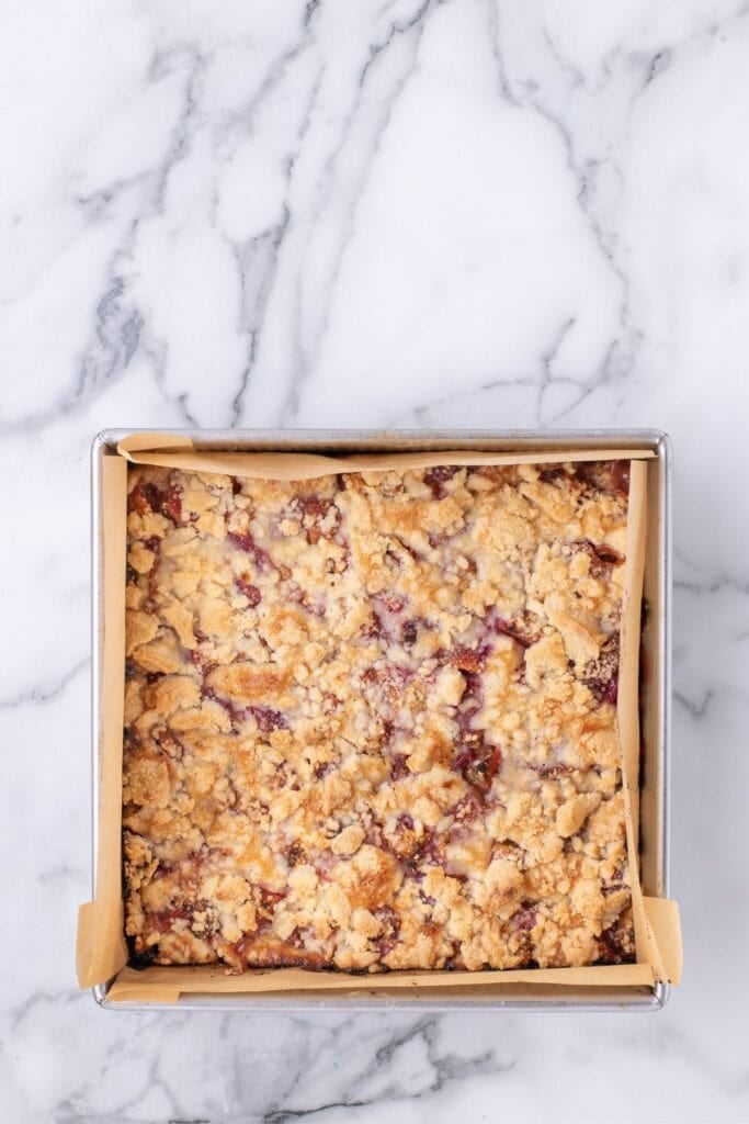 Baked bars in a parchment lined baking pan.