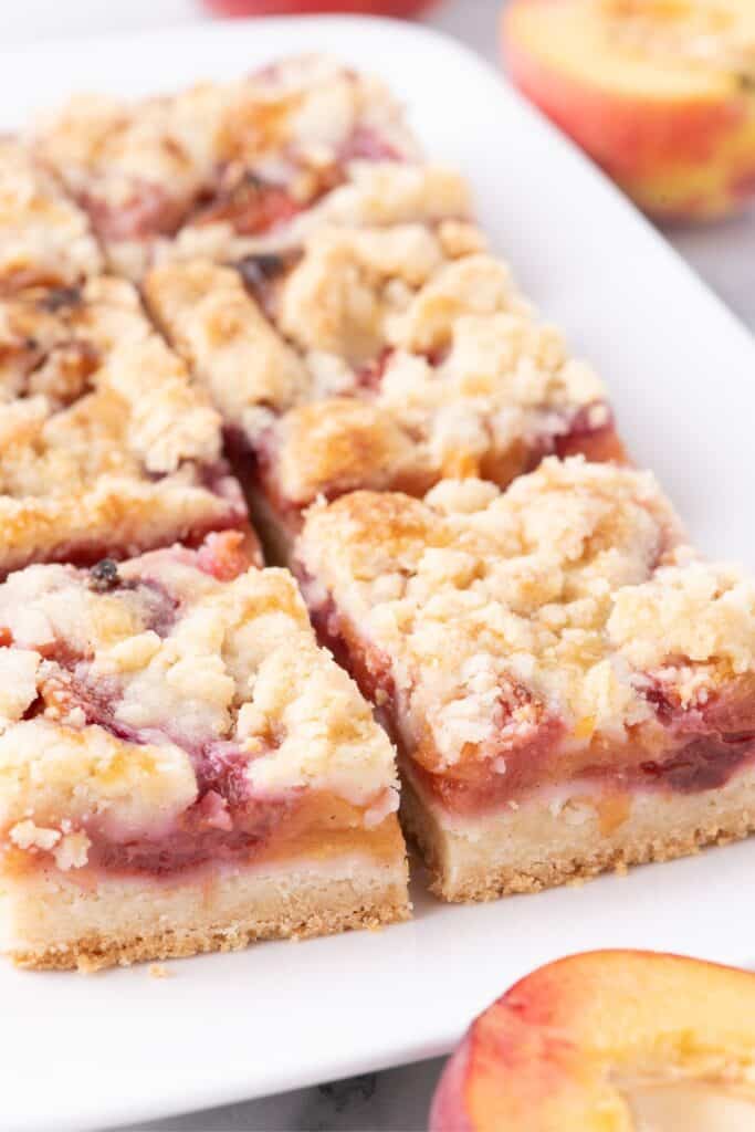 Sliced peach bars on a white platter.