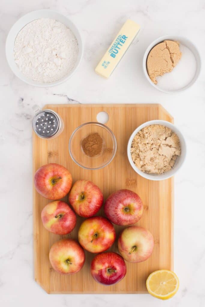 Ingredients for apple crisp without oats: apples, brown sugar, cinnamon, lemon juice, salt, flour, brown sugar, sugar, and butter.