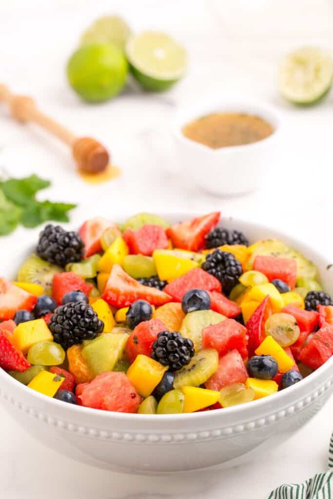 A fresh fruit salad with the dressing poured all over it.