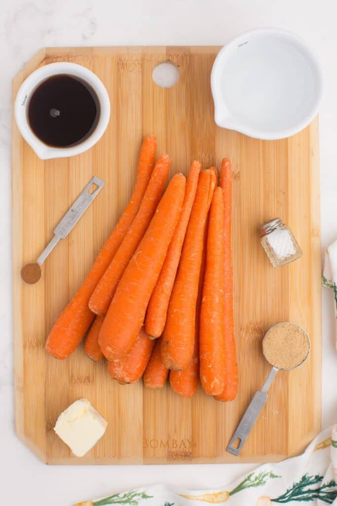 Ingredients for maple glazed carrots: carrots, water, salt, butter, unsalted, maple syrup, brown sugar, and cinnamon.