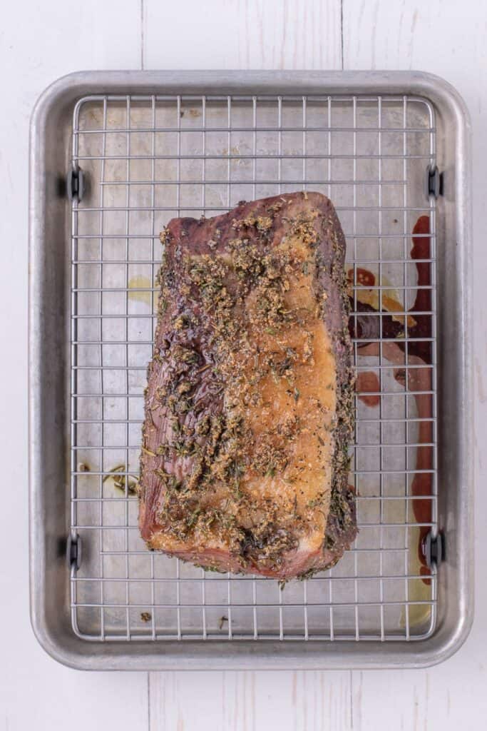 Cooked roast on a rack in a baking sheet.