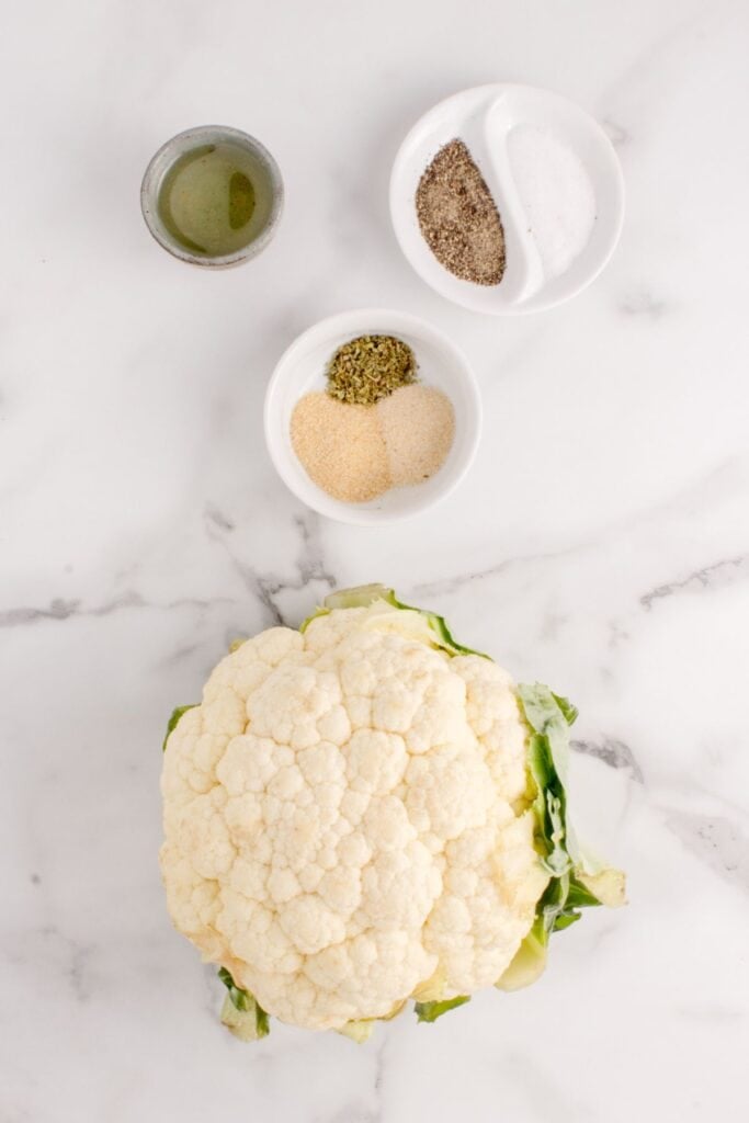Ingredients for air fryer cauliflower: Cauliflower, olive oil, garlic powder, onion powder, Italian seasoning, salt, and black pepper.