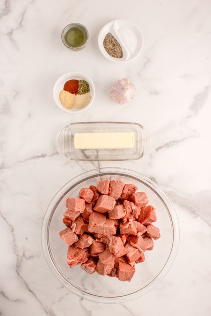 Ingredients for Garlic Butter Steak Bites: boneless steak, oil, salt, black pepper, garlic powder, onion powder, smoked paprika, Italian seasoning, unsalted butter, garlic, and parsley for garnish.