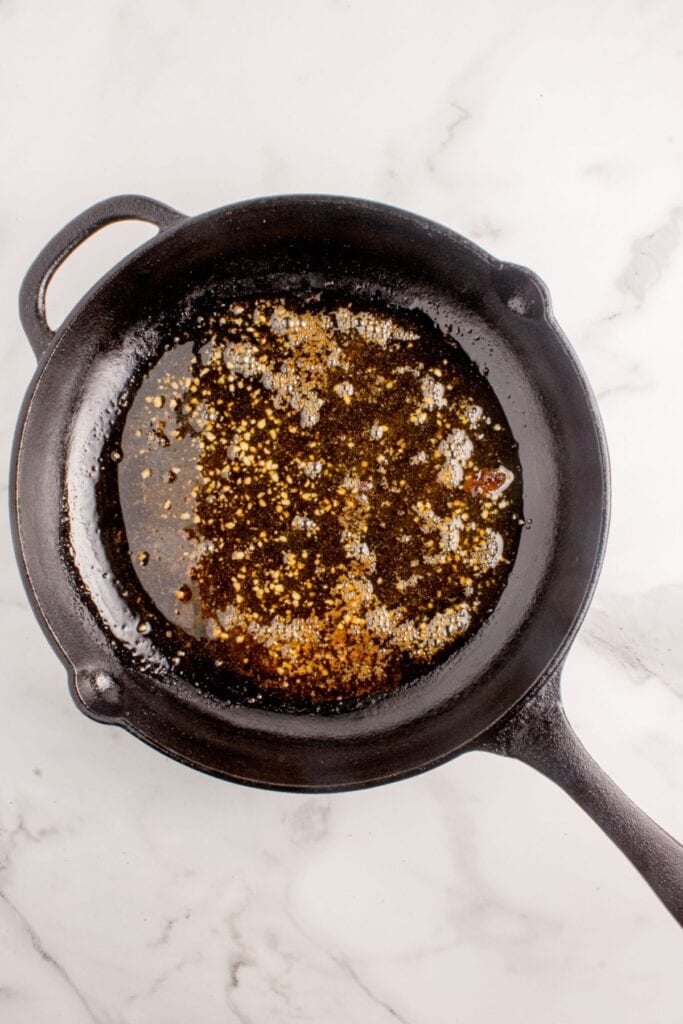 Cast iron pan with garlic butter sauce.