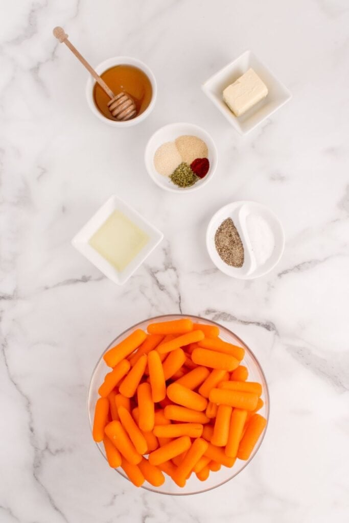 Ingredients for roasted baby carrots: baby carrots, butter, olive oil, honey, Italian seasoning, smoked paprika, garlic powder, onion powder, salt, and black pepper.