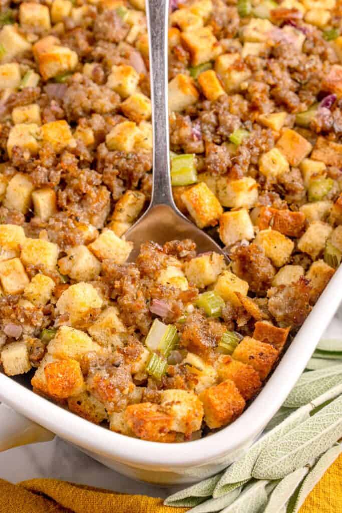 A white baking dish with completed sage and sausage stuffing in it.