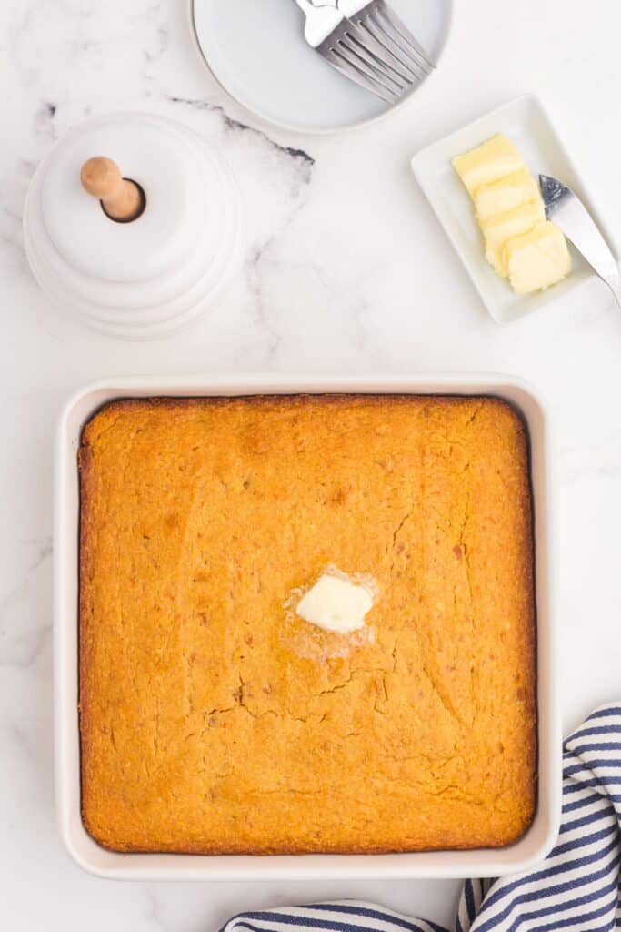 Baked sweet potato cornbread in a white square baking dish.