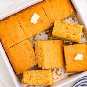 A square baking pan with sliced cornbread in it.