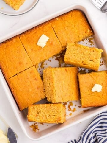 A square baking pan with sliced cornbread in it.